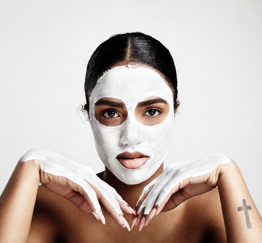 Face. Close up portrait of beautiful young woman with monstera leaf. Concept of cosmetics, makeup, natural and eco treatment, skin care. Shiny and healthy look, fashion, healthcare. Details.
